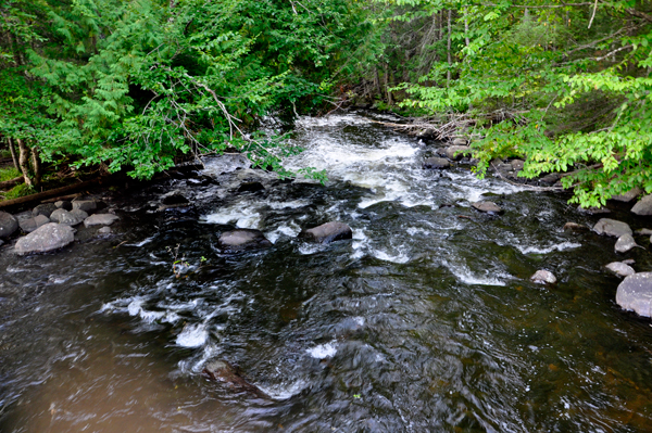 the water flows past a scattering of huge rocks